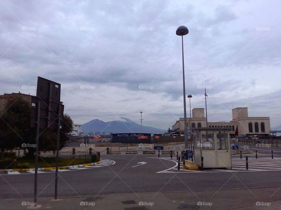 Porta di Massa and Mount Vesuvio covered with snow on a cloudy day