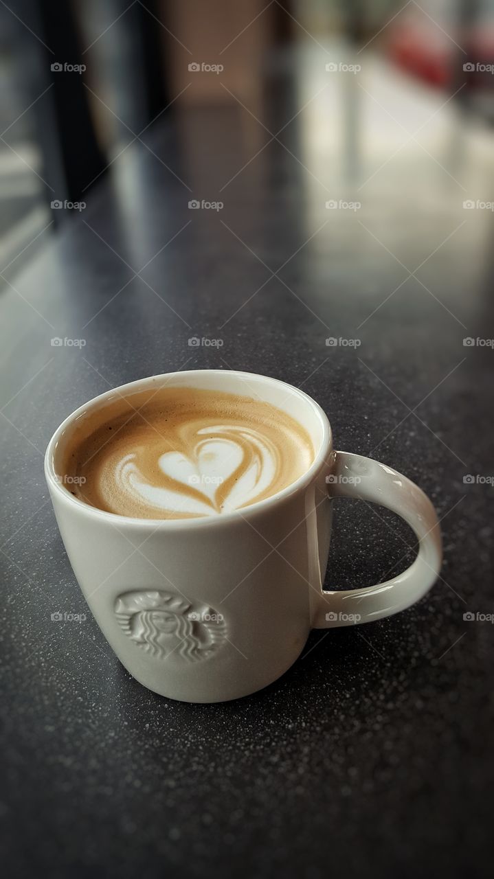 Starbucks coffee mug on a black table