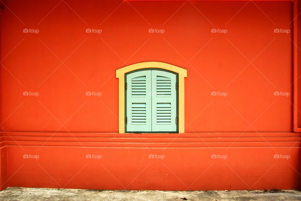 Small window on the red wall.
