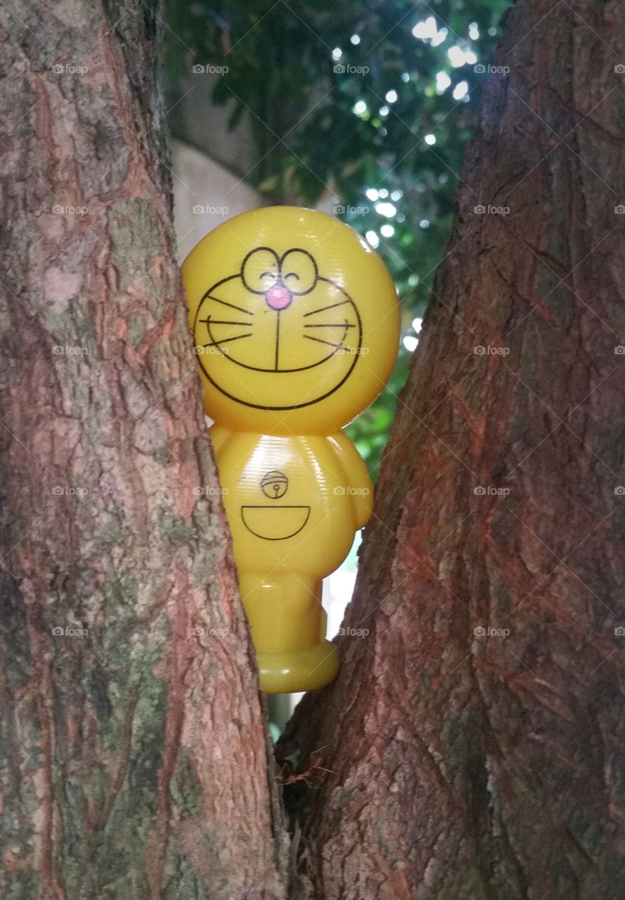 Doremon toy on a tree...