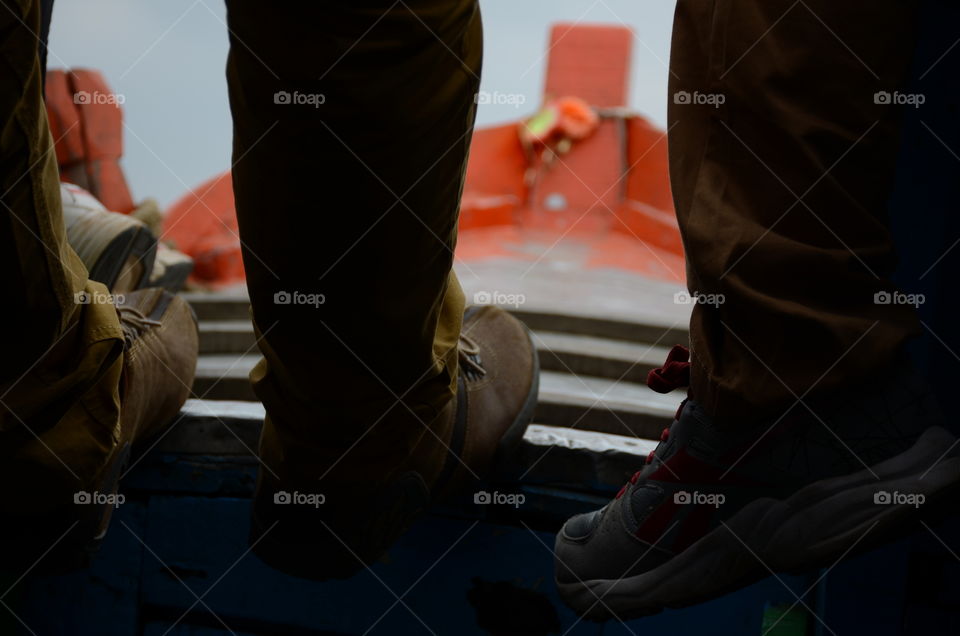 Low section of person standing on boat