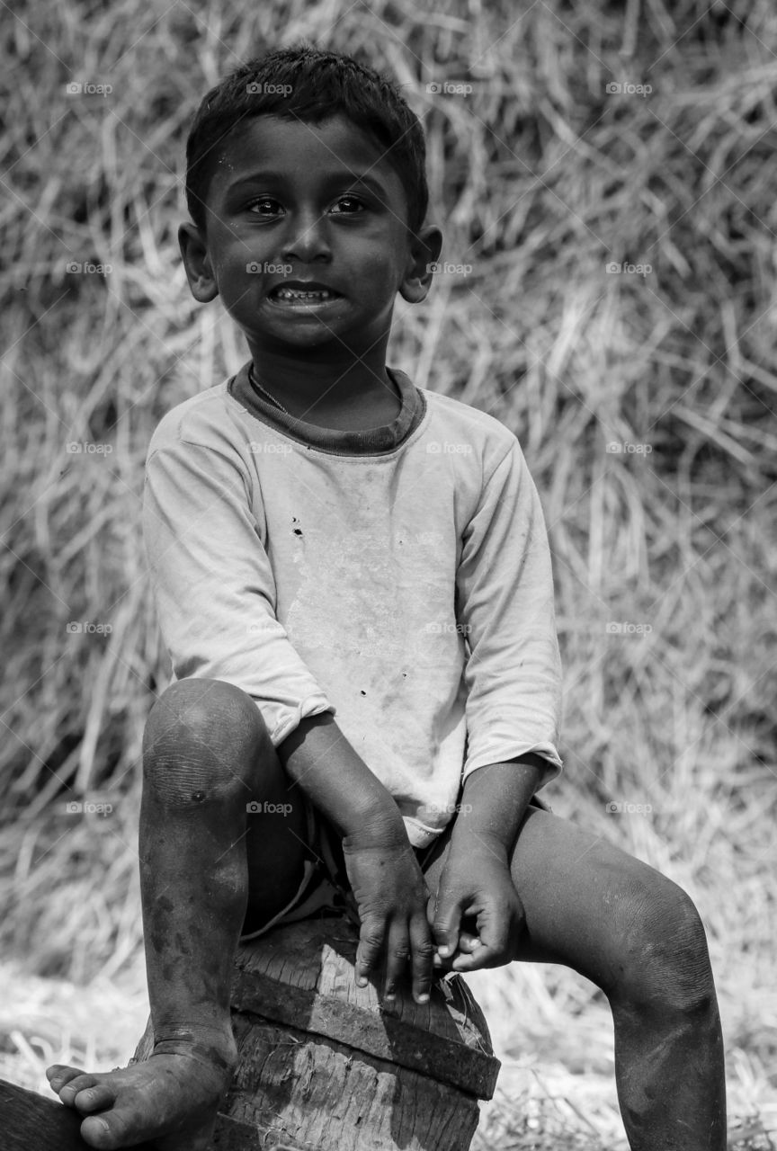 A soulful smile that shows the emotions of a poor boy