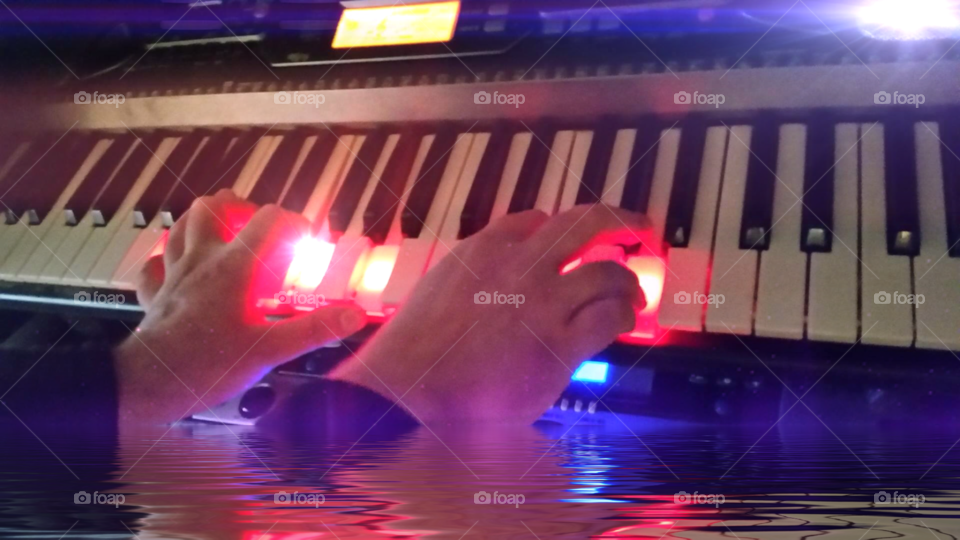 Keyboard for eBook designs. Image of my hands on a synth with a reflection effect added.