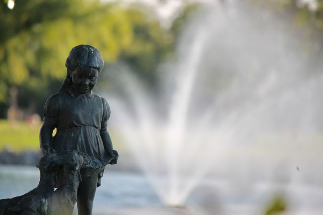 Girl Statue in front of Water Fountain 