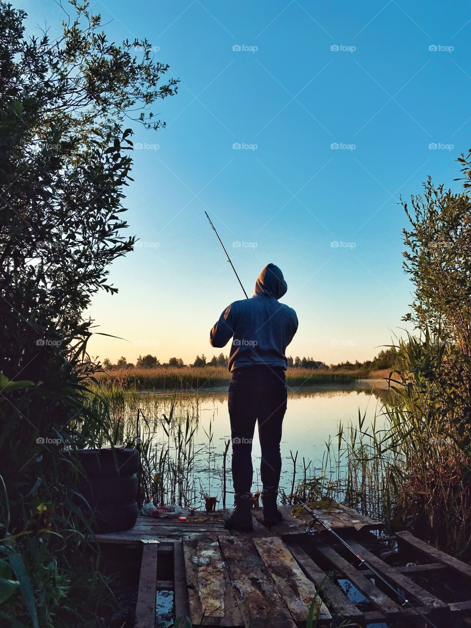 Early morning fishing in the lake. Beautiful sunrise and surroundings