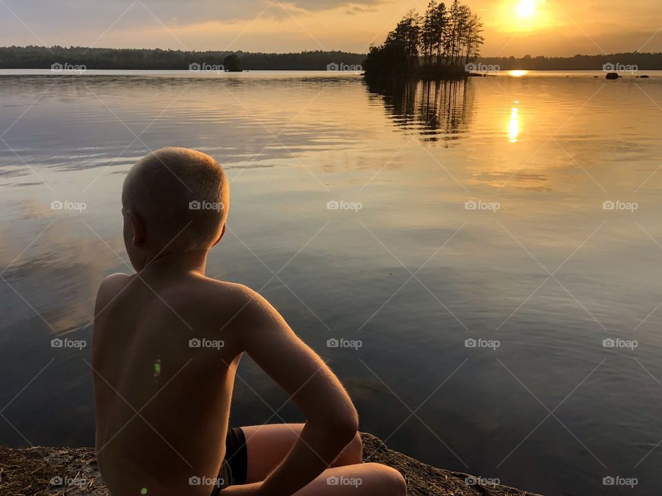 Boy sitting and enjoying the sunset