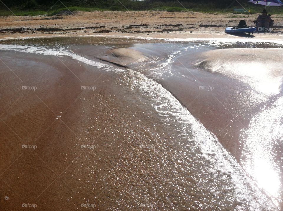 Waves on the beach. Waves washing away part of the shore 