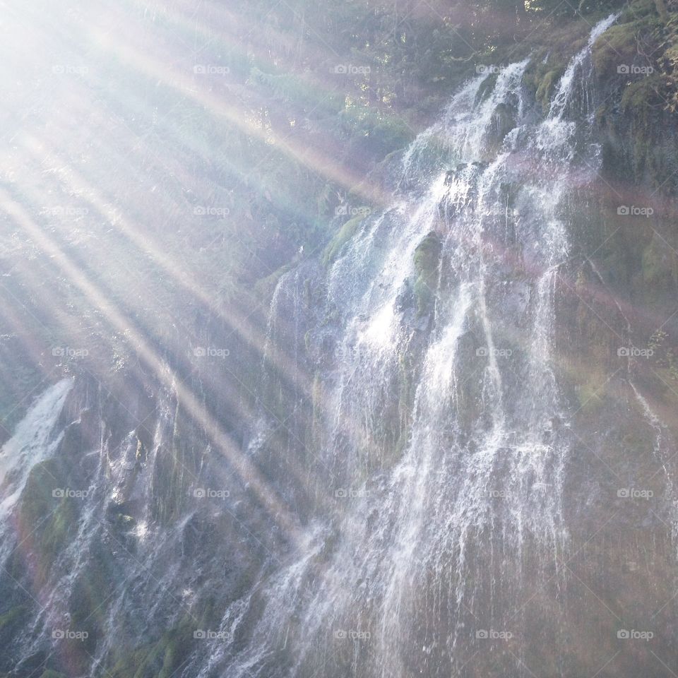Sun rays shine on Panther Creek Falls in Washington State.