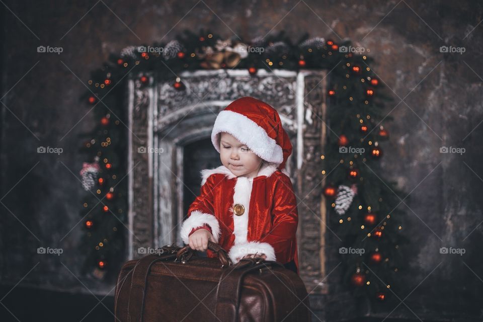 little santa collects a suitcase with gifts