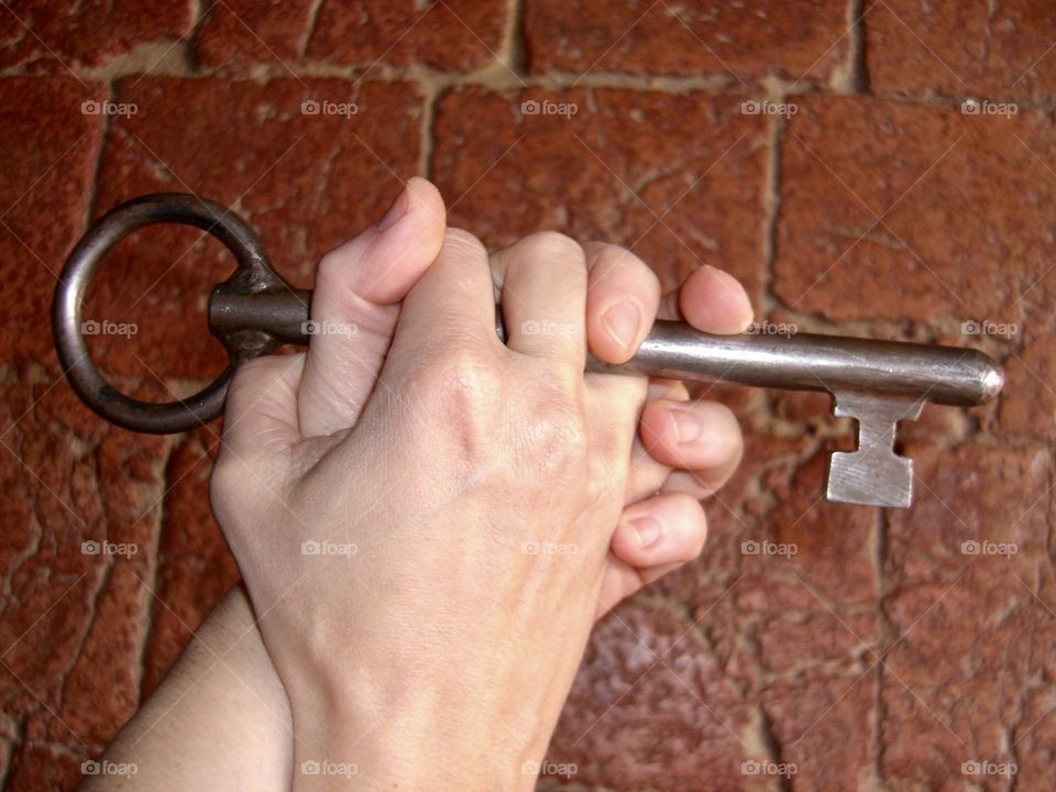 Hands hugging with castle key 