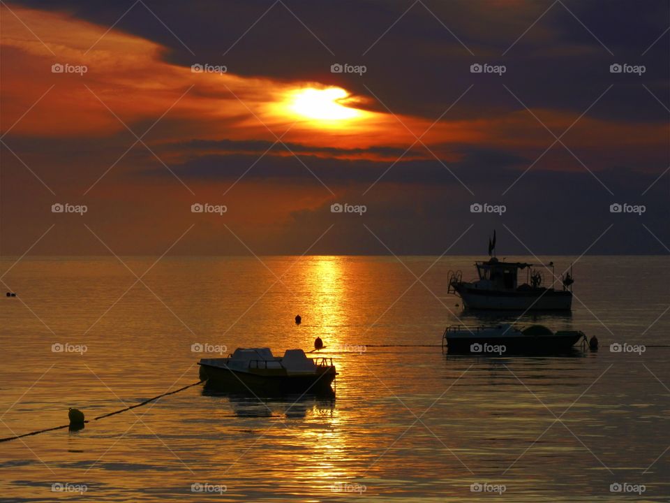 Sunlight and boats in the sea of Praia ( Italy ).