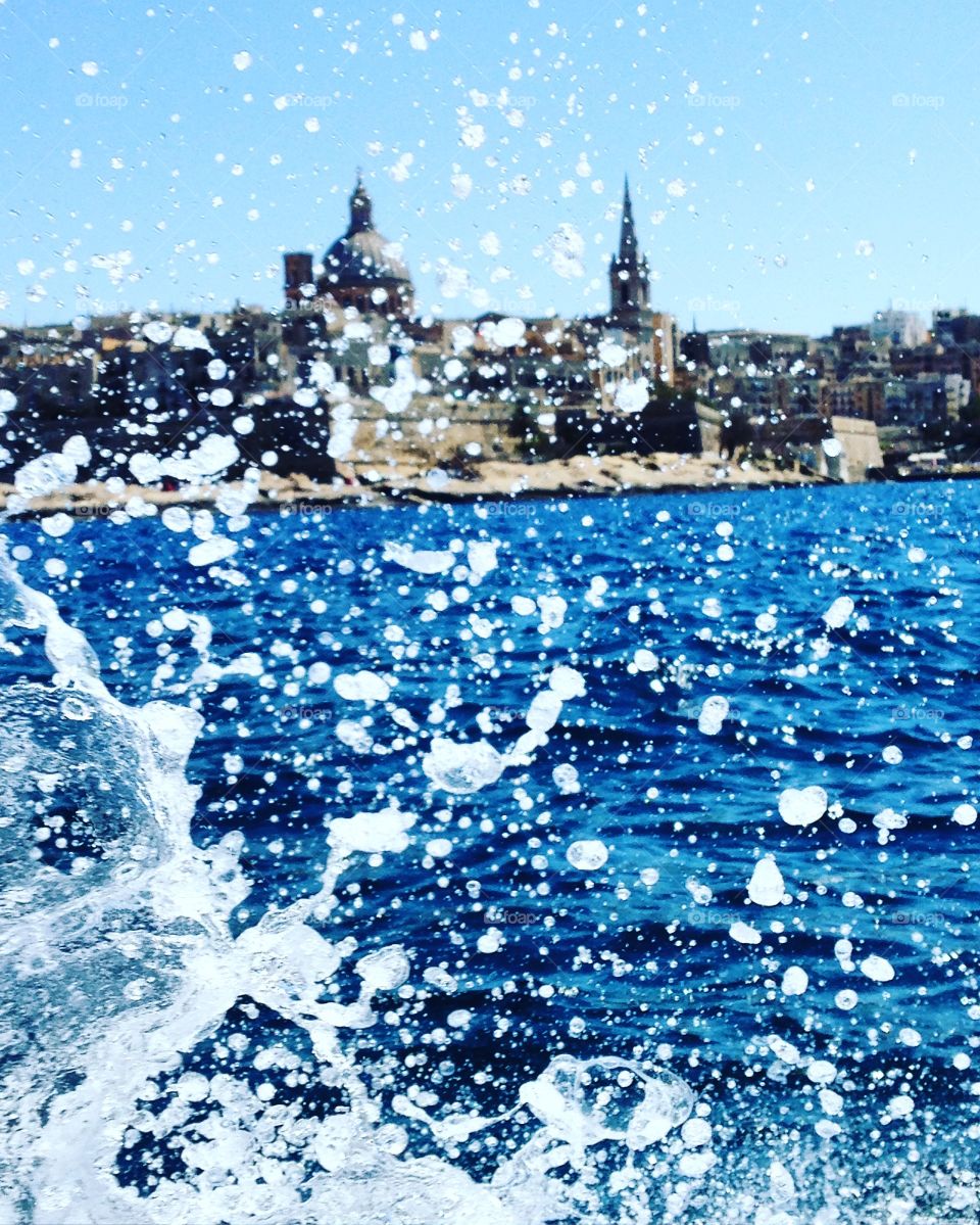 Amazing view of Valletta with splash of the water by a boat