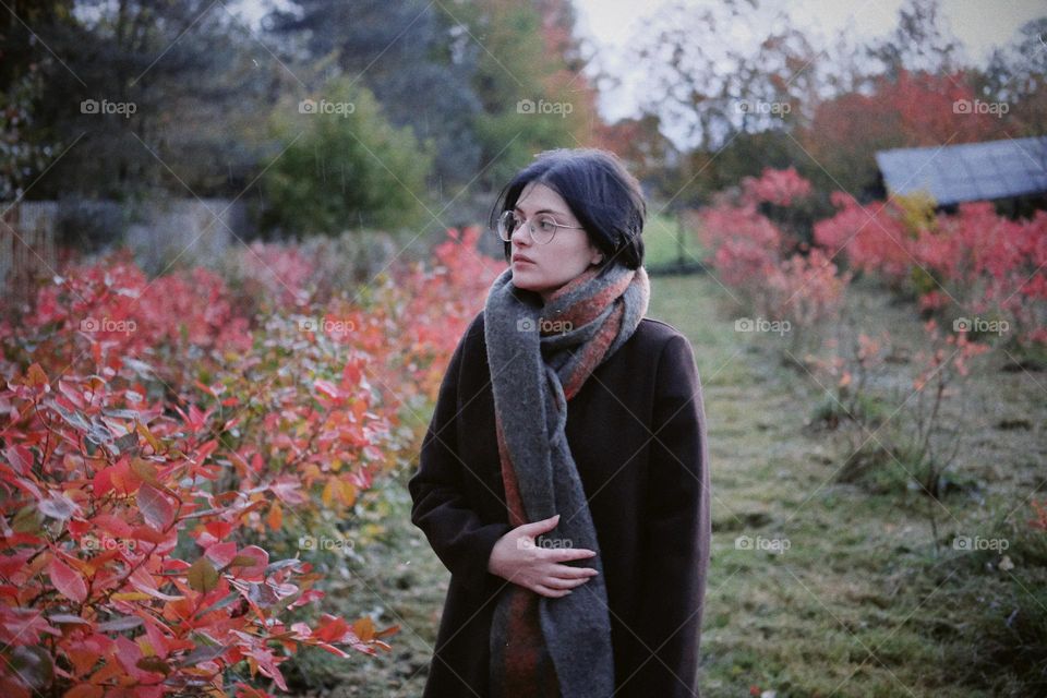 Young girl on the background of autumn foliage