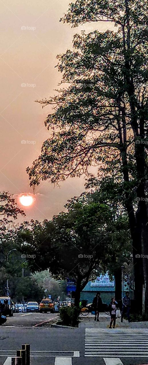 sunrises, sunsets and the moon: capturing sunset of urban road during off work.