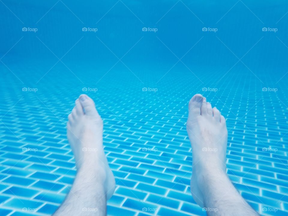 foot view underwater relaxing summer at the pool