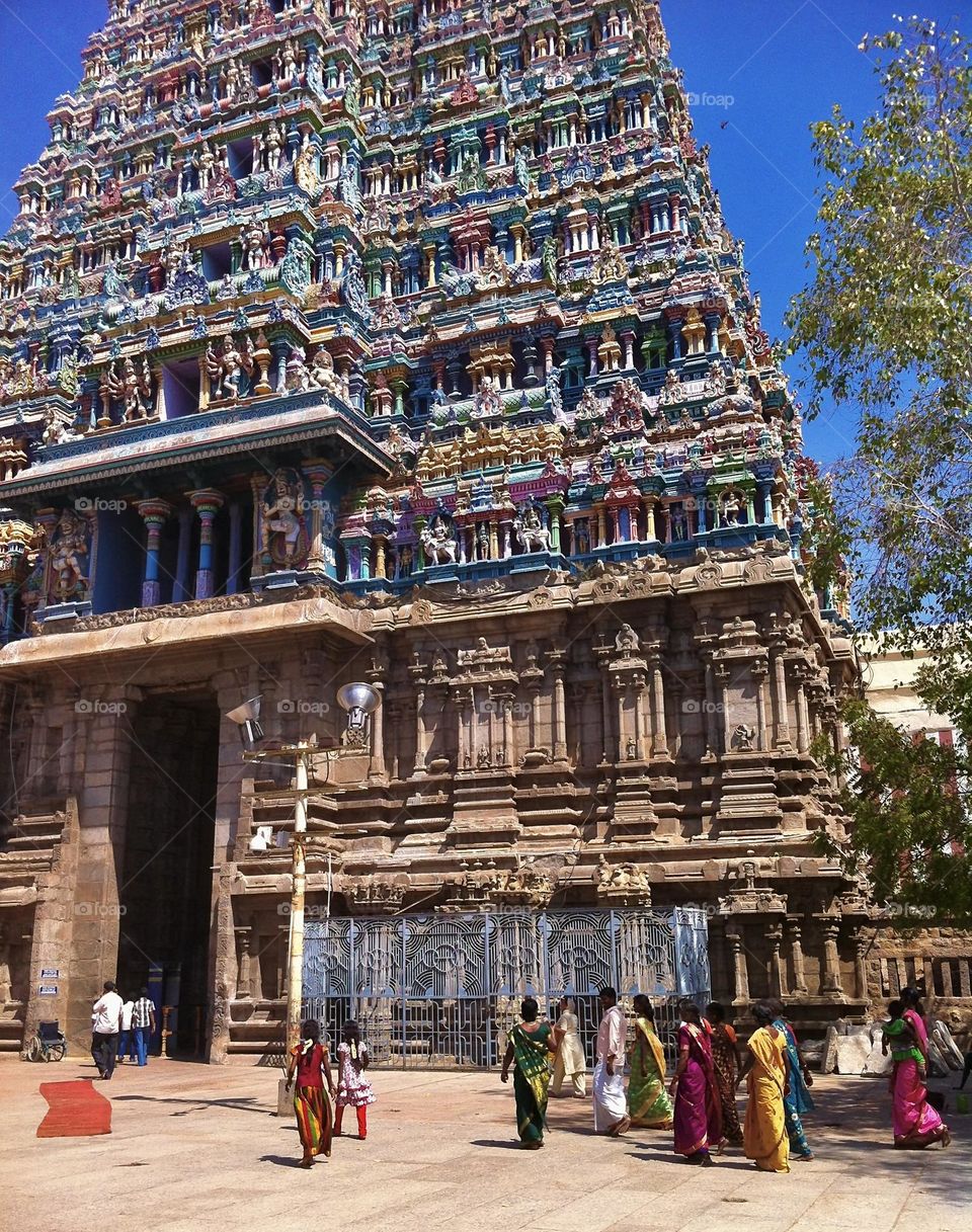 Colorful people and Hindu temple in Madurai, Tamil Nadu, India