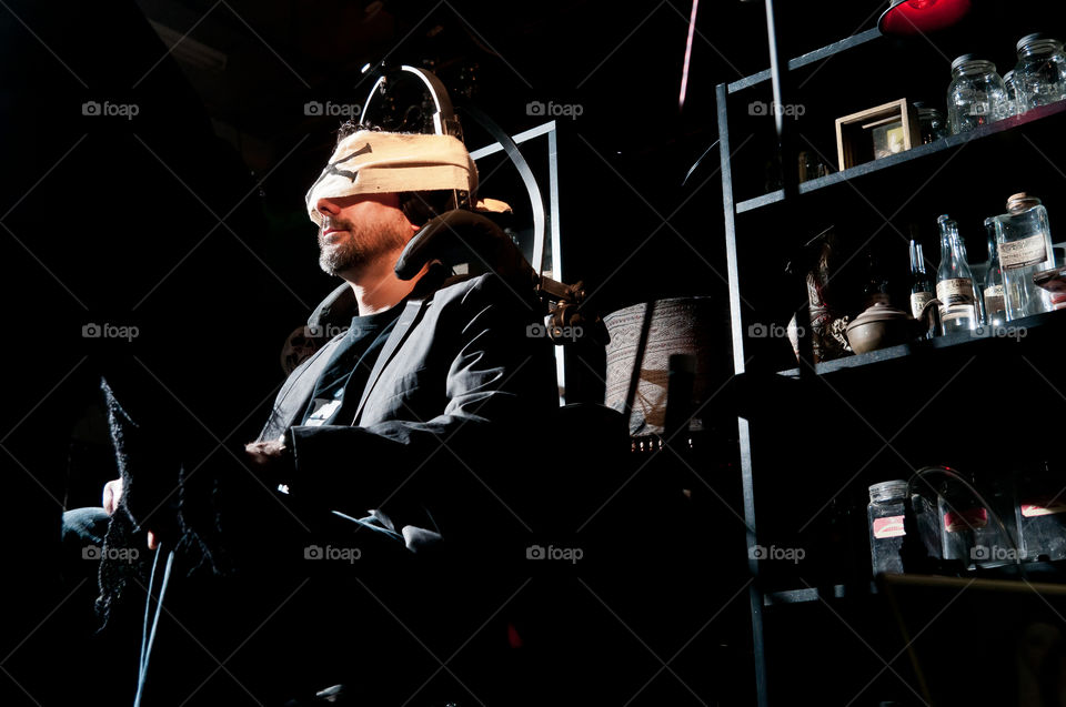 Man sitting on electric chair blindfolded