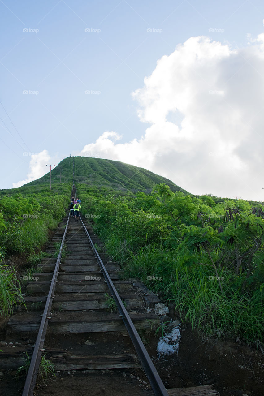 Distant view of people walking on railroad track