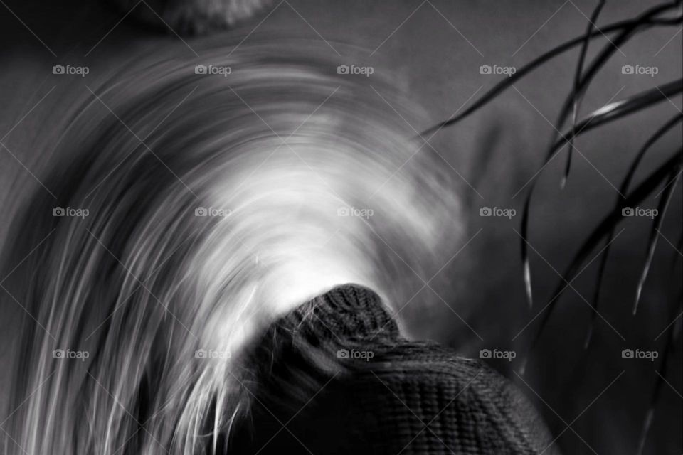 Long exposure of a woman shaking her long hair