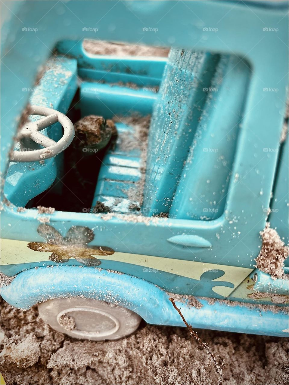 Frog hiding in Toy Scooby Doo Van outside in Sand. 