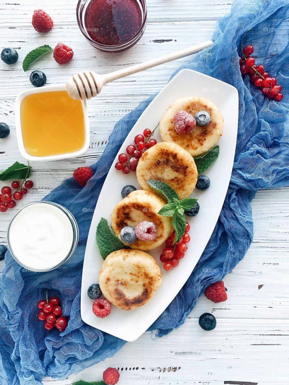 Cheese pancakes on plate with berries