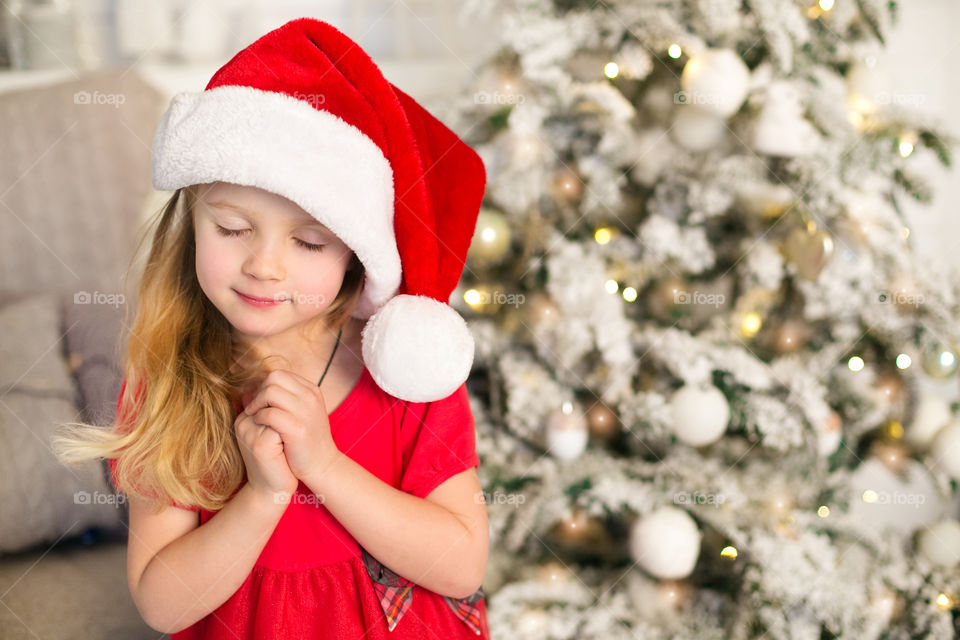 Portrait of girl wearing santa hat in christmas