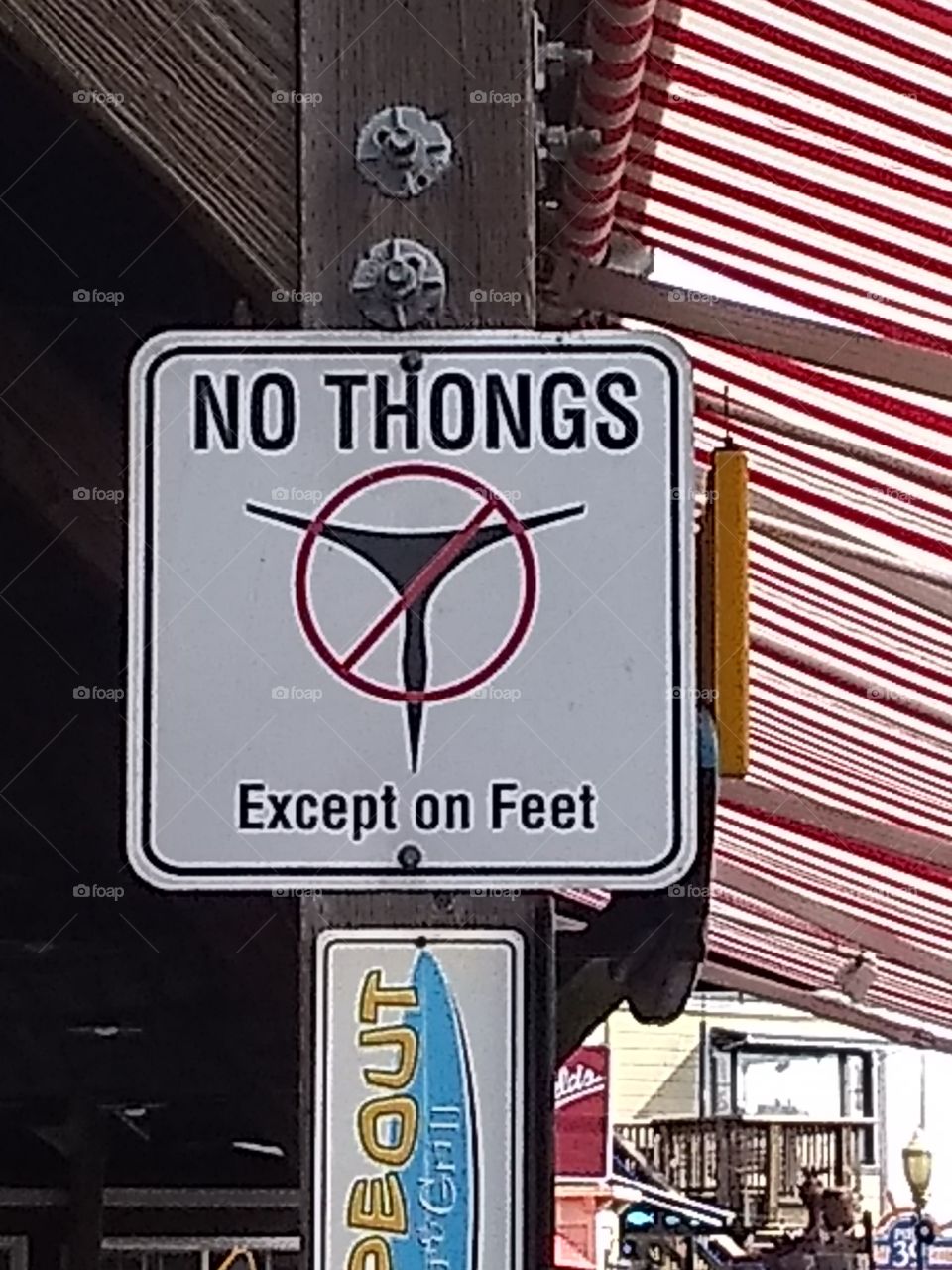 Sign seen in San Francisco.  Naturally, I and others nearby who also found themselves in violation, removed our things at once. I was in a skirt, so, but for a moment of adjustment to a cool breeze, compliance was simple for me. Others? A struggle.