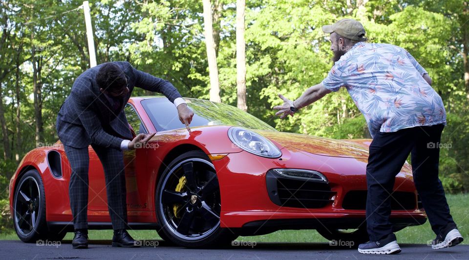 “Enragement Photo Session;” Two Men “enraged” due to a spot on a red sports car