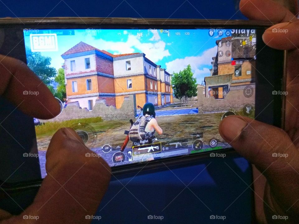 a boy playing PUBG BGMI on phone