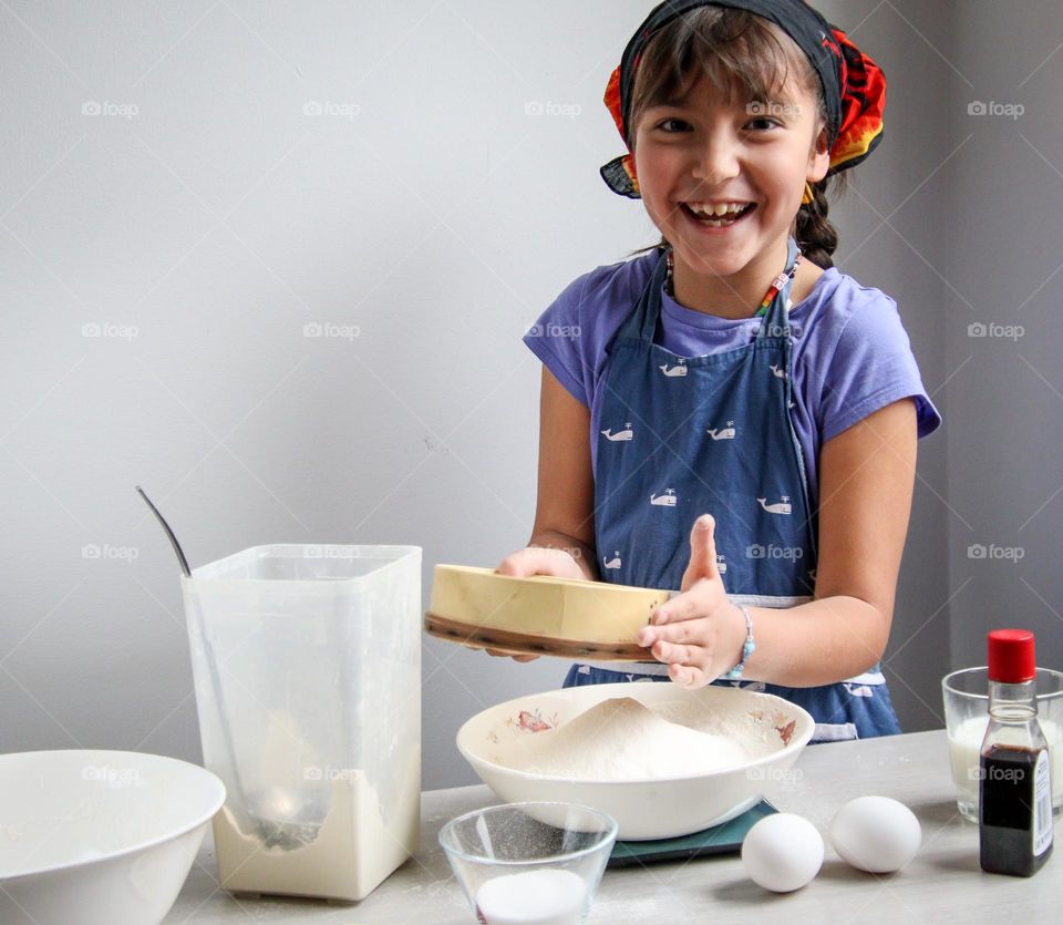 Happy cute girl is cooking