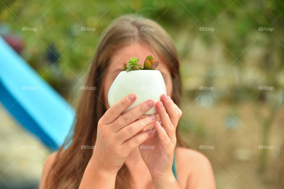 Girl holding a cactus pot