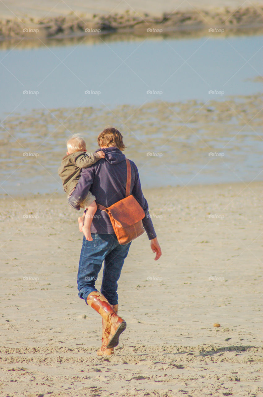 Mother And The Child At The Beach