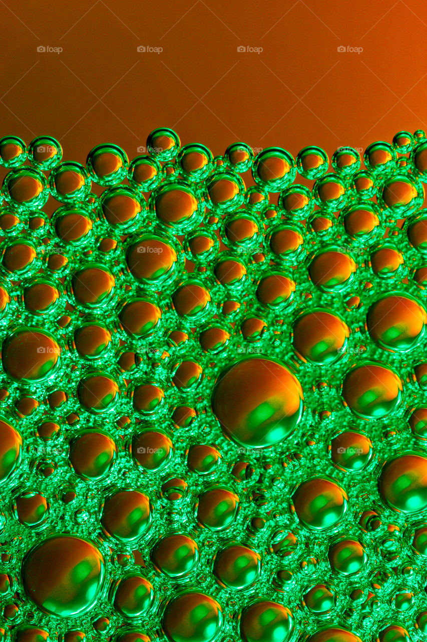 Green Bubbles in front of Orange Background