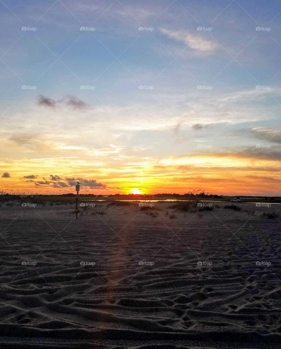 This is a gorgeous September sunset over Fort Fisher Kure Beach, NC area. we drove the jeep on the sand for a photo shoot and I took this as we were leaving.
