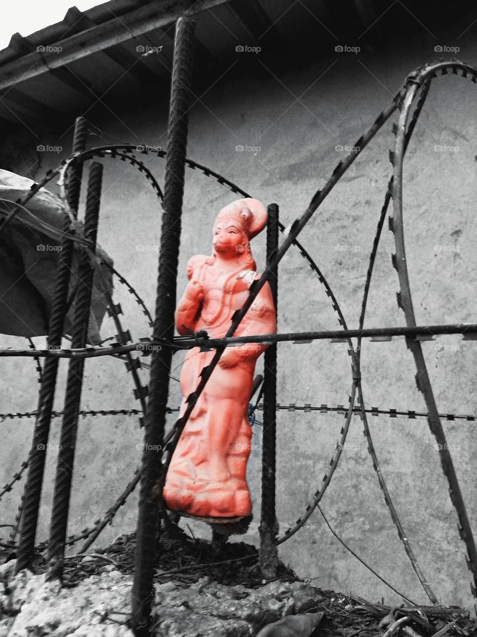 A figure of lord Hanuman stuck inside wires.