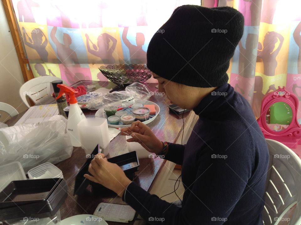 Woman putting labels on plastic trays.