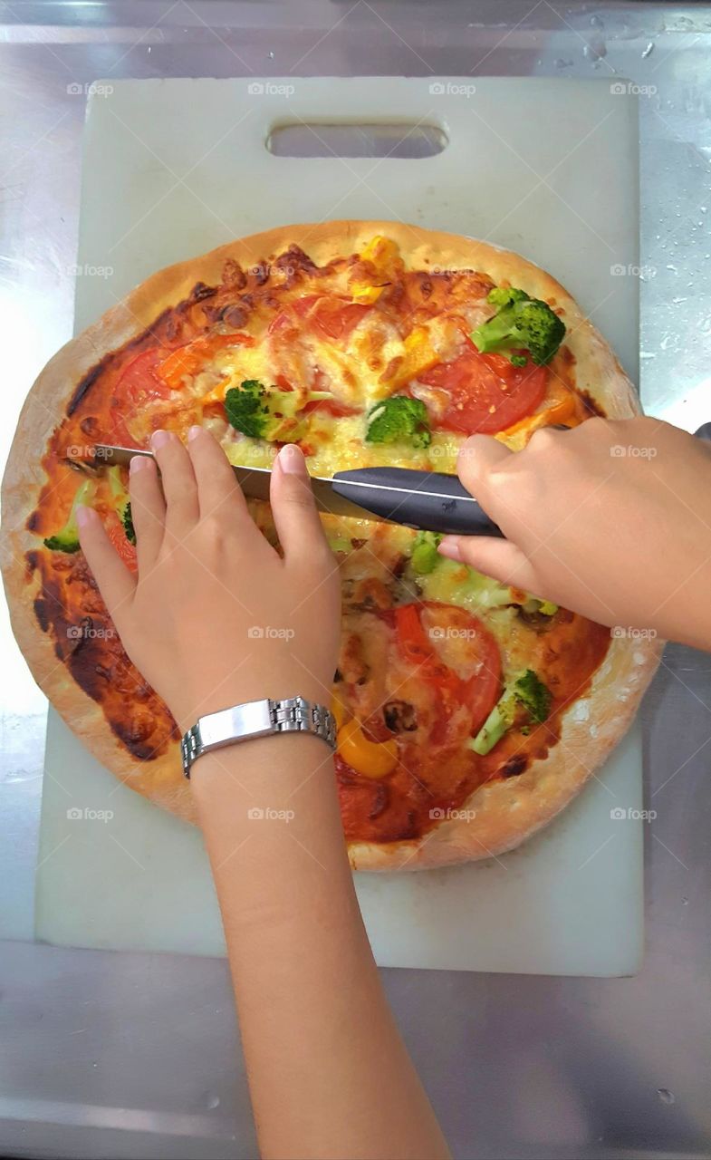 Artisanal pizza with tomato and broccoli and bell pepper and mozzarella