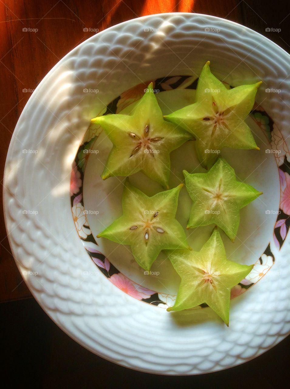 Slices of star fruit on a plate