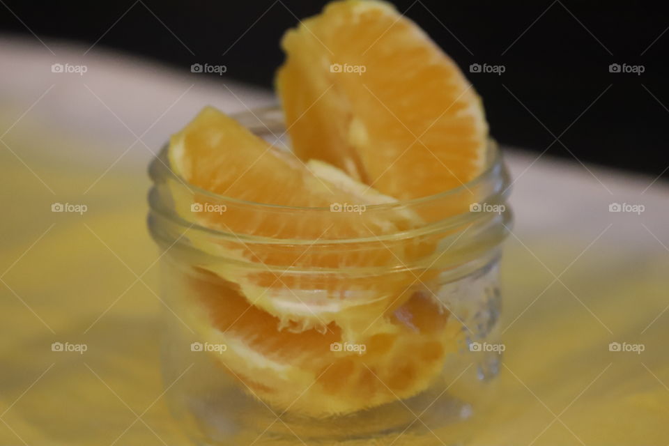 Sliced oranges in a glass jar 