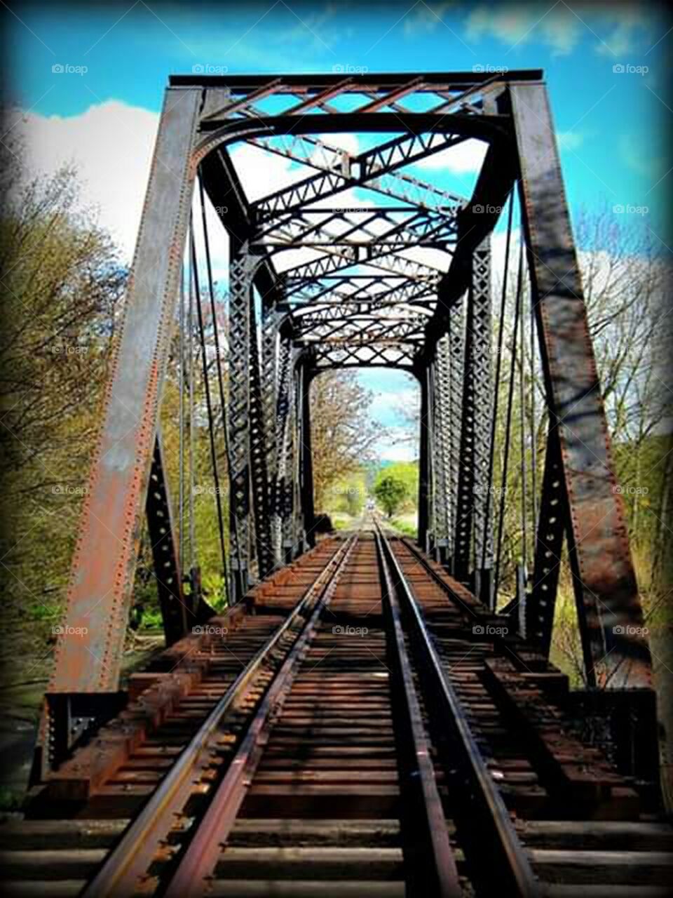 colorful image of train bridge and blue sky