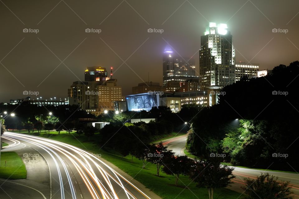 Foap, Day and Night: view of the Raleigh, North Carolina skyline on a foggy night. Raleigh’s infamous color-changing shimmer wall is front and center. 