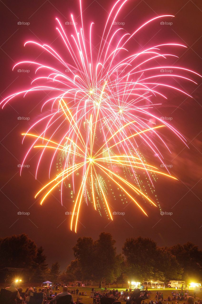 Pink and orange color explosion firework burst on black background. 