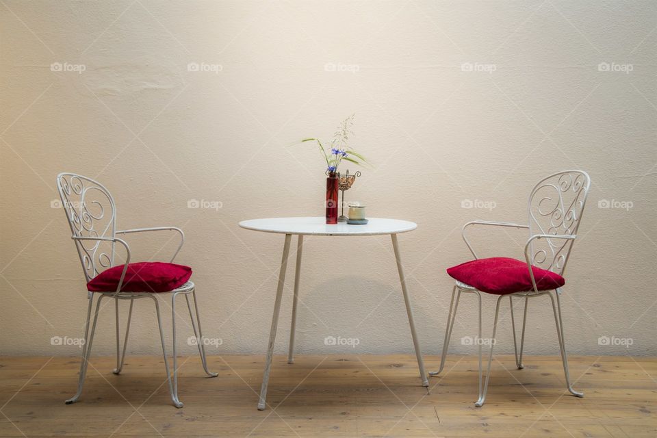 chairs and table with flowers