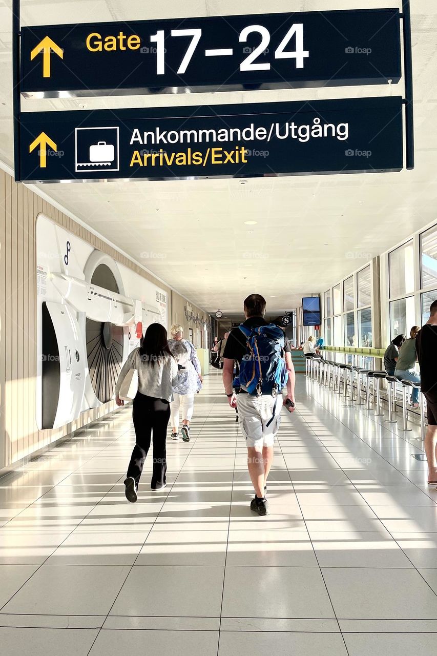 People leaving the airplane walking towards the exit in the airport 