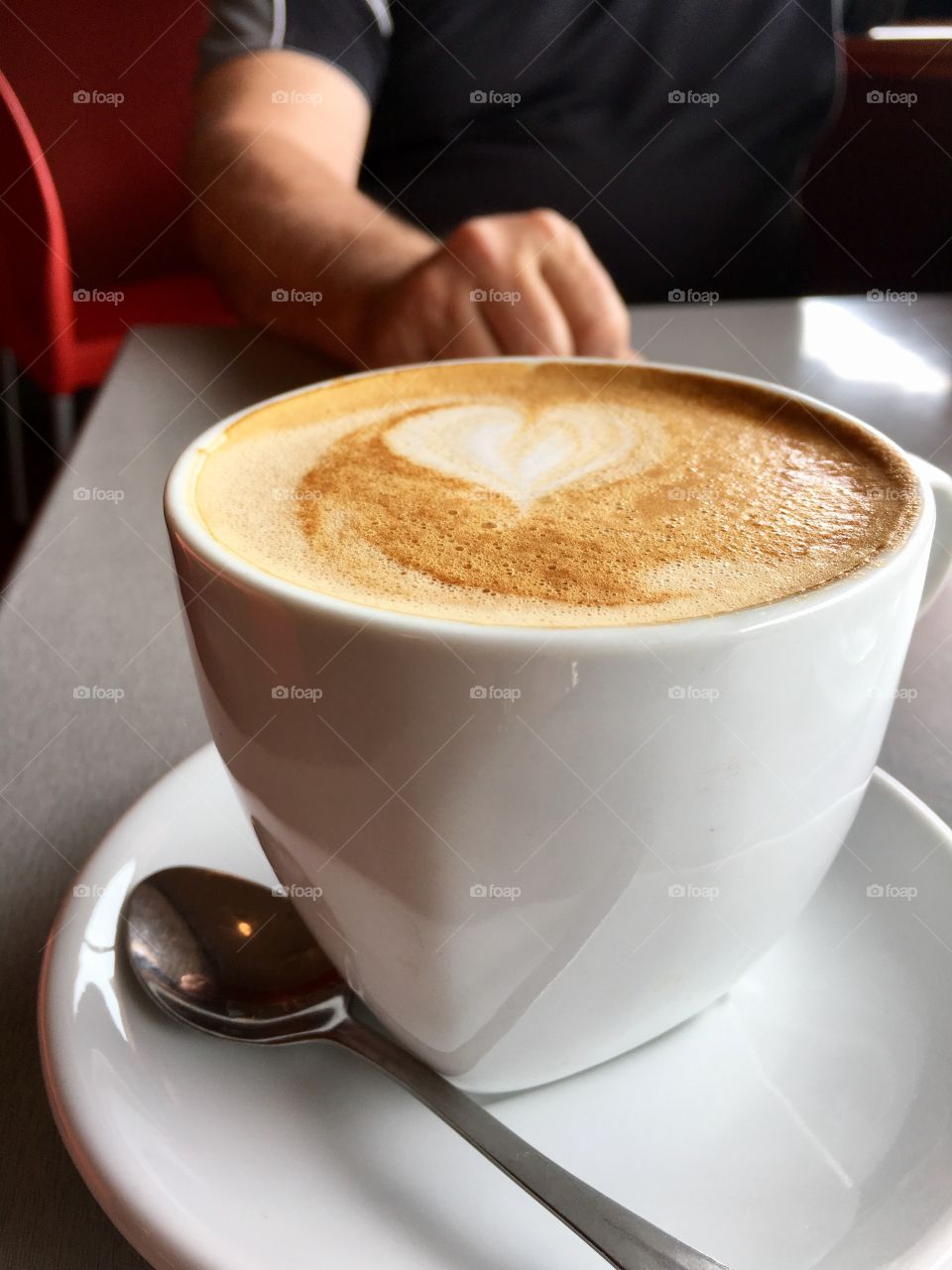 Heart shape in white cup of cafe latte 