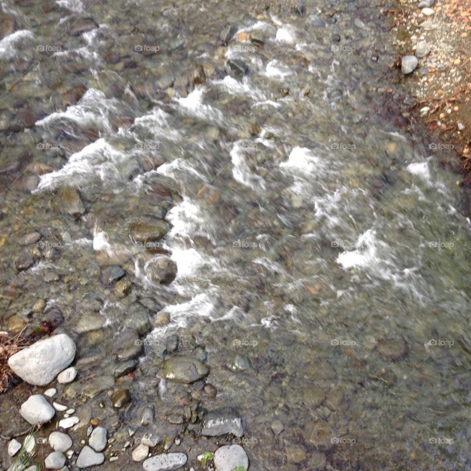 Mountain stream flowing over pebbles.