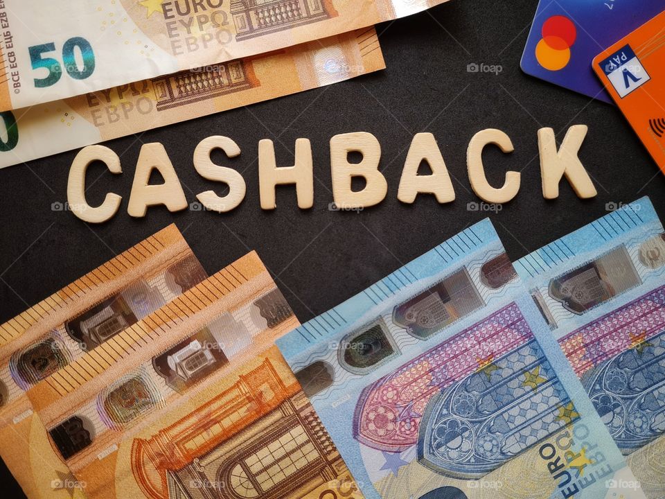 background with cashback writing and banknotes and credit cards