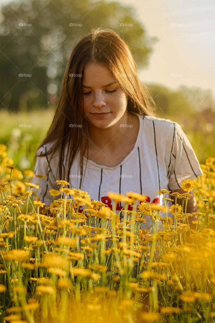 girl in the field of yellow flowers.