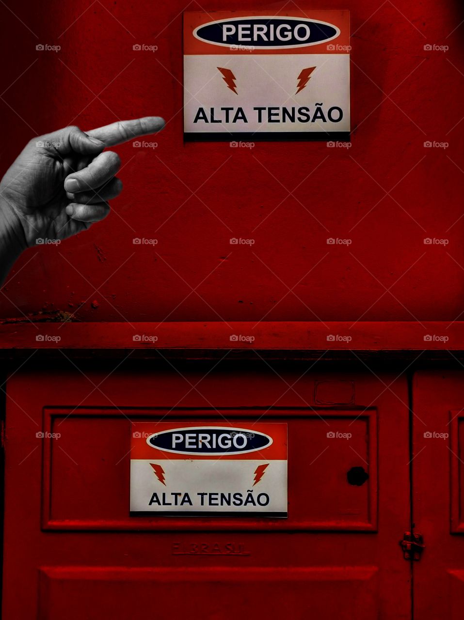 red wall with high voltage warning sign