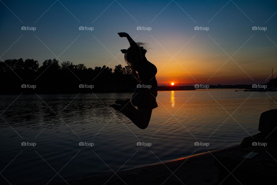 Jumping happy woman at the beatch a springtime day in the sunset ..
Warm colors at the beach